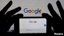 A smartphone and computer screen display the Google home page. Australia is one step closer to forcing tech firms to give police access to encrypted data.