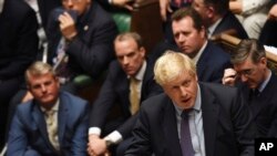 FILE - Caption Britain's Prime Minister Boris Johnson speaks in the House of Commons following the debate for the EU Withdrawal Agreement Bill, in London, Oct. 22, 2019.