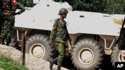 A Bangladeshi soldier walks as they try to flush out Islamist radicals who have holed up in a building with a large cache of ammunition in the city of Sylhet, Bangladesh, March 26, 2017. 