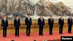 China's new Politburo Standing Committee members (L-R) Han Zheng, Wang Huning, Li Zhanshu, Xi Jinping, Li Keqiang, Wang Yang and Zhao Leji, line up as they meet with the press at the Great Hall of the People in Beijing, China October 25, 2017. 