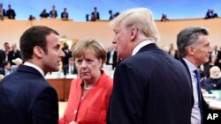 Francuski predsednik Emanuel Makron, nemačka kancelarka Angela Merkel i američki predsednik Tramp na samitu G20. 
