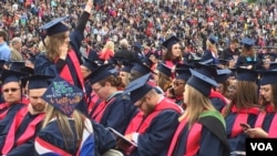 Some of the six thousand Liberty University graduates are seen in the school's football stadium for the university's 44th commencement, in Lynchburg, Virginia, May 13, 2017. (C. Presutti/VOA)