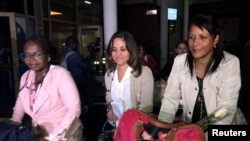 FILE - Cuban doctors arrive at the Jomo Kenyatta International Airport amid controversy surrounding their pay in Nairobi, Kenya, June 5, 2018. 