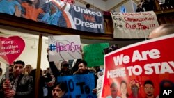 FILE - Immigrant rights advocates demonstrate against President-elect Donald Trump's immigration policies during a rally at Metropolitan AME Church in Washington, Jan. 14, 2017.