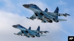 Su-27 fighter jets fly above a military base in the Zhytomyr region, Ukraine, Thursday, Dec. 6, 2018. 