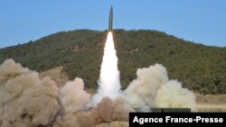 This picture taken on Jan. 14, 2022, and released from North Korea's official Korean Central News Agency on Jan. 15 shows the firing of a railway-borne missile, in Pyongan province. 