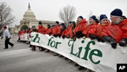 Anti-abortion activists march past the Capitol in Washington, Friday, Jan. 25, 2013, to the Supreme Court as they observe the 40th anniversary of the Roe v. Wade decision.