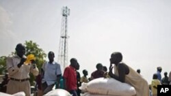 Southern Sudanese who recently returned from northern Sudan receive food rations from the World Food Program in the southern capital of Juba on Friday, Jan. 7, 2010.