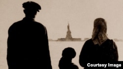An immigrant family views the Statue of Liberty from Ellis Island in New York. 