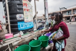 FILE - Women wash their hands in Goma, Democratic Republic of Congo, July 31, 2019.