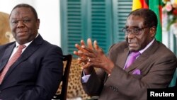 Zimbabwean President Robert Mugabe (R) and Prime Minister Morgan Tsvangirai address a media conference in Harare, January 17, 2013.