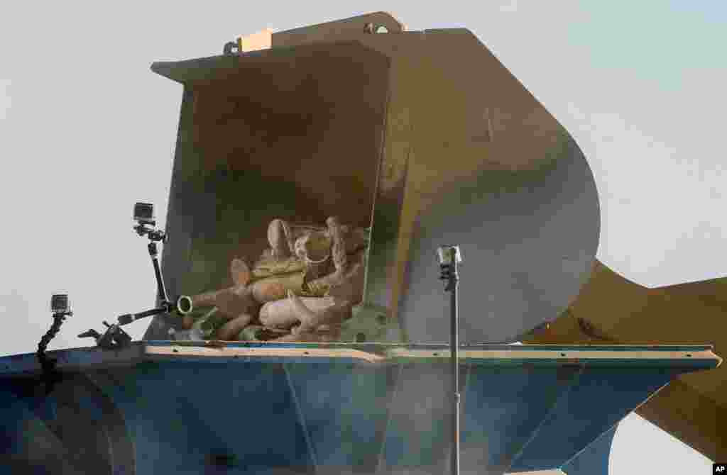 A front end loader dumps ivory into a giant rock crusher to be pulverized, at the National Wildlife Property Repository, at Rocky Mountain Arsenal National Wildlife Refuge, in Commerce City, Colo., Nov. 14, 2013.