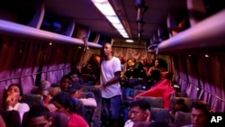 FILE - People wait on board a bus, on their way to the U.S. border, in Tegucigalpa, Honduras, Aug. 20, 2019.
