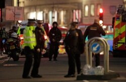 Armed police officers stand on the north side of London Bridge in London, Nov. 29, 2019.