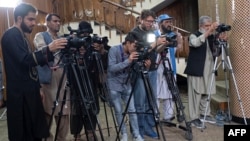 FILE - Afghan journalists attend a press conference by Afghanistan's Minister of Foreign Affairs Amir Khan Muttaqi, in Kabul on September 19, 2024.