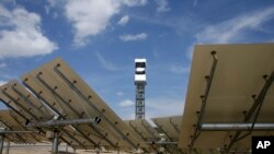 A concentrating solar power plant in Primm, Nev., is seen in this file photo. The site uses over 300,000 mirrors to focus sunlight on boilers' tubes atop 450 foot power towers heating water into steam which in turn drives turbines to create electricity. 