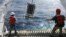 MBARI Scientists aboard Research Vessel Western Flyer shown recovering a water sampling device in the North Pacific Ocean, which is used to collect algae. (photo credit: Adam Monier)