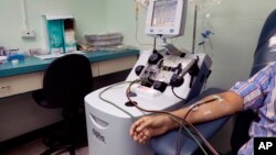 A recovered COVID-19 patient donates blood at the Arnulfo Arias Madrid Hospital, in Panama City, Wednesday, May 13, 2020. The blood product donated from recovered COVID-19 patients, known as convalescent plasma, may have antibodies that can help those cri