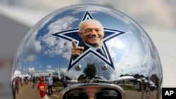 Dallas Cowboys fan Gregg Wilson, of Dallas, arrives for the Pro Football Hall of Fame inductions, including that of Cowboys owner Jerry Jones, whose photo is on the helmet, at the Pro Football Hall of Fame on Saturday, Aug. 5, 2017, in Canton, Ohio.
