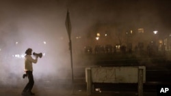 A protester confronts police in front of the Brooklyn Center Police station on April 11, 2021, in Brooklyn Center, Minn. 