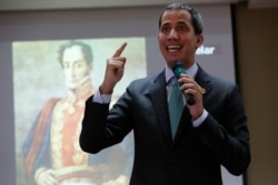 FILE - Venezuelan opposition leader and parliamentary president Juan Guaido addresses lawmakers of the National Assembly, in front of an image of Venezuelan independence hero Simon Bolivar, in Caracas, Venezuela, Sept. 3, 2019.