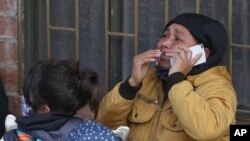 The relative of an inmate cries as she speaks on the phone outside La Modelo jail in Bogota, Colombia, where violence broke out of inmates' fears that authorities are not doing enough to prevent coronavirus inside overcrowded prisons.