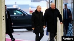 Russian President Vladimir Putin and Belarusian President Alexander Lukashenko arrive for meeting in Minsk