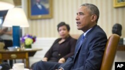 Attorney General Loretta Lynch listens as President Barack Obama speaks in the Oval Office of the White House in Washington, Jan. 4, 2016, during a meeting with law enforcement officials to discuss actions the president can take to curb gun violence in the U.S.