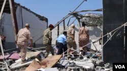 Libyan officials investigate the bombing of a detention center holding civilian migrants that killed dozens of people and injured more than 130, pictured on July 3, 2019. (H. Murdock)