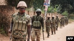Ugandan soldiers patrol near the street leading to the house of Robert Kyagulanyi, also known as Bobi Wine, in Magere, Uganda, Jan. 18, 2021.