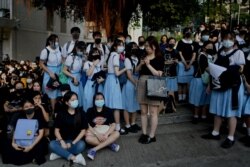 Schoolmates and protesters gather in support of student Tsang Chi-kin, 18, who was shot in the chest by police during violent pro-democracy protests that coincided with China's Oct. 1 National Day. The student is in stable condition.