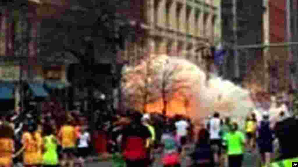 In this image from video provided by WBZ-TV, spectators and runners run from what was described as twin explosions that shook the finish line of the Boston Marathon, April 15, 2013.