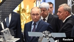 FILE - Russia's President Vladimir Putin, accompanied by head of the Roscosmos space corporation Yuri Borisov, visits the centre of the Rocket and Space Corporation "Energia" in Korolyov outside Moscow, Russia, October 26, 2023. (Sputnik/Sergei Bobylev/Pool via REUTERS)