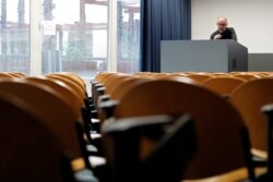 FILE - University Chemistry professor Luca De Gioia records his lesson in an empty classroom to stream it online for his students at the Bicocca University in Milan, Italy, March 2, 2020.