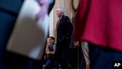 Senate Majority Leader Mitch McConnell of Ky. walks onto the Senate floor following a Senate policy luncheon on Capitol Hill in Washington, Jan. 23, 2018. 
