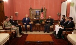 Afghanistan's President Ashraf Ghani, right, and U.S. special envoy for peace in Afghanistan, Zalmay Khalilzad, left, meet in Kabul, Nov. 10, 2018.