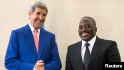President of the Democratic Republic of Congo (DRC) Joseph Kabila (R) welcomes U.S. Secretary of State John Kerry at the Palais de la Nation in Kinshasa, May 4, 2014. 