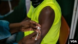 A Zimbabwean receives a COVID-19 vaccine jab at Wilkins Hospital - Zimbabwe’s main vaccination center in Harare on May 12, 2021 when things were still on course. Then shortages began. (Columbus Mavhunga/VOA)