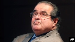 In this Oct. 18, 2011 file photo, U.S. Supreme Court justice Antonin Scalia looks into the balcony before addressing the Chicago-Kent College Law justice in Chicago. 