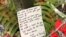 A note to the victims of Friday's mass shooting was placed alongside 50 red paper hearts near the Al Noor mosque in Christchurch, New Zealand, March 18, 2019.