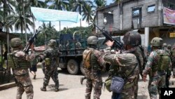 FILE - In this May 30, 2017 photo, Philippines government troops prepare to head to the frontline as fighting with Muslim militants in Marawi city continued in southern Philippines. 