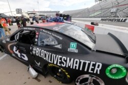 FILE - The car for driver Bubba Wallace has a Black Lives Matter logo as it is prepared for a NASCAR Cup Series auto race in Martinsville, Va., June 10, 2020.