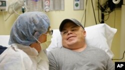 Brian Madeux sits with his girlfriend Marcie Humphrey while waiting to receive the first human gene editing therapy at the UCSF Benioff Children's Hospital in Oakland, California, Nov. 6, 2017. 