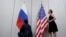 FILE - Staffers install U.S. and Russian flags as part of a bilateral meeting, Aug. 26, 2016. Theoretically, U.S. President Donald Trump and Russian President Vladimir Putin would have an opportunity to meet Friday in Vietnam but it's not clear whether the two will talk face-to-face.