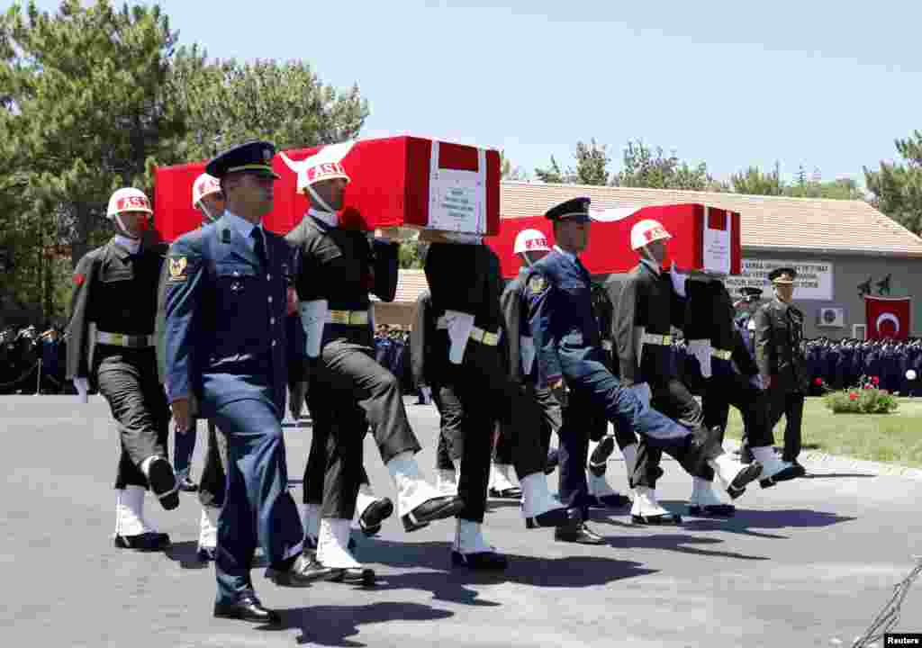 Turkish soldiers carry the coffins of fallen Turkish pilots, Captain Gokhan Ertan and Lieutenant Hasan Huseyin Aksoy, Malatya, Turkey, July 6, 2012. 