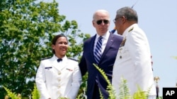 President Joe Biden congratulates Cadet Daisy Anne Atayan, one of the first two female Philippine Coast Guard-sponsored cadets, left, during the commencement at the U.S. Coast Guard Academy in New London, Conn., May 19, 2021. 
