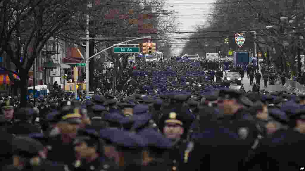 Police officers from across the country gather for the funeral of New York Police Department Officer Wenjian Liu at Aievoli Funeral Home, in the Brooklyn borough of New York, Jan. 4, 2015,.