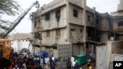Rescue workers search bodies at the site of a burnt chemical factory, in Karachi, Pakistan, Aug. 27, 2021.