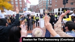 Pro-Thai democracy protesters make a three-finger salute during a clash between pro-Thai democracy protesters and Thai royalists during the demonstration at King Bhumibol Adulyadej Square in Cambridge, MA Nov 1, 2020.