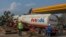 FILE - A tanker offloads fuel at Petroda Filling Station in the capital Lilongwe, Malawi, October 1, 2021.